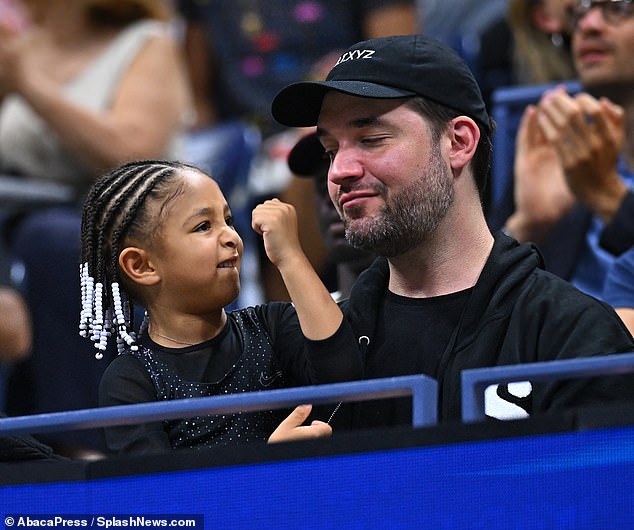 Christmas Girl: Along with a photo of himself curling up to kiss his daughter, the proud father also shared a photo of Olympia doing her fist while apparently watching one of her mother's last tennis matches; The duo seen on August 29