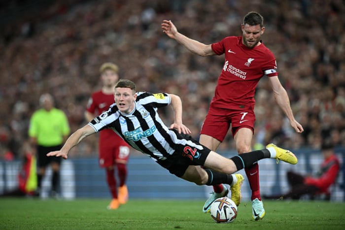 Newcastle United's Elliot Anderson travels after being challenged by Liverpool's James Milner.