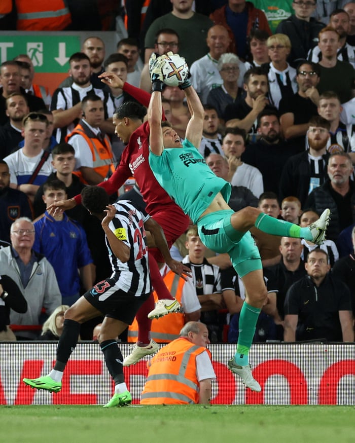 Nick Pope from Newcastle receives the ball ahead of Liverpool's Virgil van Dijk.