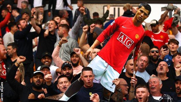 Manchester United fans hold Cristiano Ronaldo out of cardboard at Wolverhampton