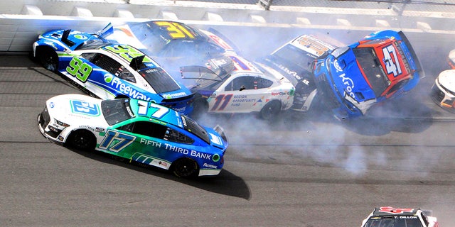 Chris Bucher (17), Daniel Suarez (99), Denny Hamlin (11), Justin Haley (31), Ty Dillon (42), Eric Almerola (10) and Ricky Stenhouse Jr (47) participate in a multi-car crash between Turns 1 and 2 during the Auto Race of the Cup Series NASCAR at Daytona International Motorcycle, Sunday, August 28, 2022, in Daytona Beach, Florida.