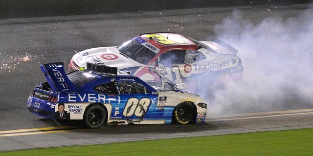 David Starr (08) slides backwards along the front extension after hitting a multiple car wreck as Myatt Snider (31) passes during the NASCAR Xfinity Series car race at Daytona International Speedway, Saturday, August 27, 2022, in Daytona Beach, Florida.